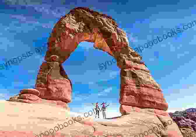 Hiker Standing Under Delicate Arch The 10 Best Hikes Around Moab Including Arches National Park