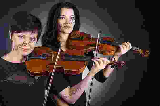 Two Violinists Performing A Duet On Stage 25 Beautiful Classical Melodies For Violin Duet